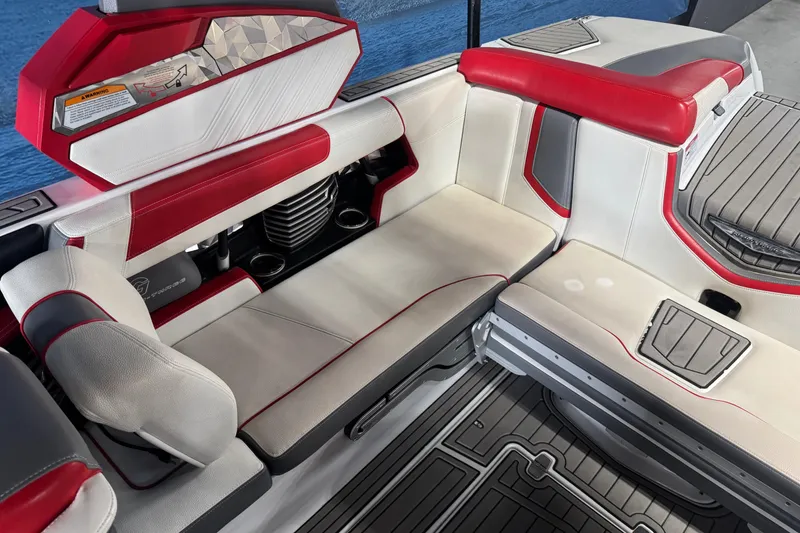 Slide: The Image of 2019 Nautique Super Air Nautique G23 interior with red and white seating, cup holders, and sleek design. - 7