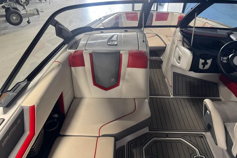 Slide: The Image of 2019 Nautique Super Air Nautique G23 interior with red and gray accents, featuring spacious seating. - 9