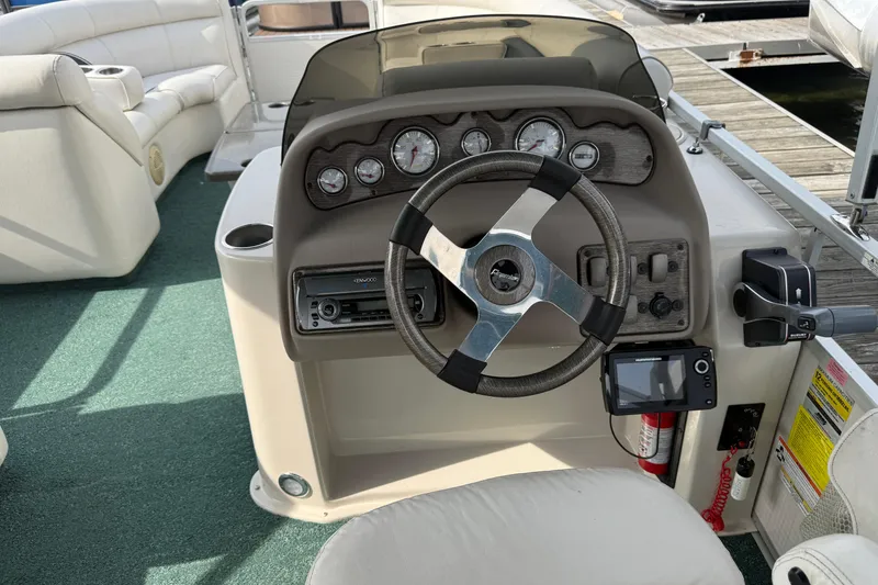 Slide: The Image of Steering console of a 2007 Premier 22 boat with gauges and controls. - 11