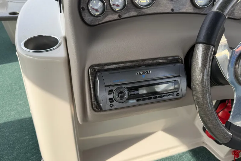Slide: The Image of Boat dashboard with Kenwood stereo, cup holder, and steering wheel in a 2007 Premier 22. - 12