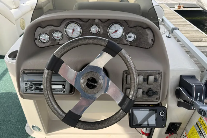 Slide: The Image of Steering console of a 2007 Premier 22 boat with gauges and controls. - 15