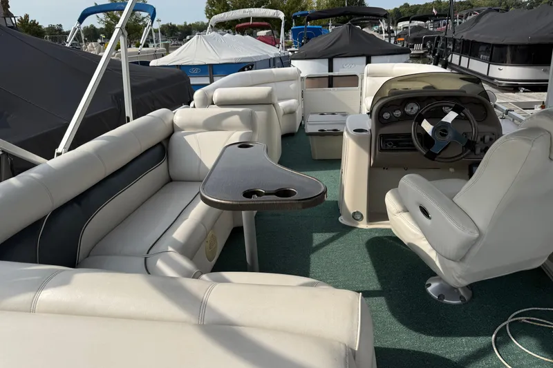 Slide: The Image of Interior of a 2007 Premier 22 boat with white seating and steering console. - 24