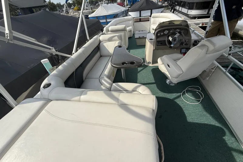 Slide: The Image of 2007 Premier 22 boat interior with white seating and steering console. - 25