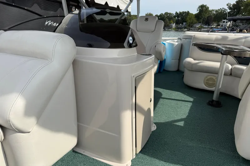 Slide: The Image of Interior of a 2007 Premier 22 boat with white seating and green carpet. - 6