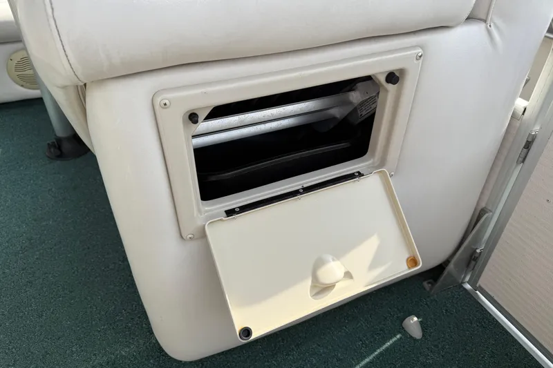 Slide: The Image of Open storage compartment in a 2007 Premier 22 boat with white upholstery. - 9