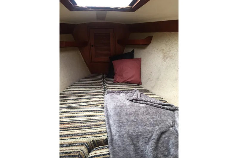Slide: The Image of Cozy cabin interior of 1982 Tartan 33 sailboat with striped cushions and pillows. - 4