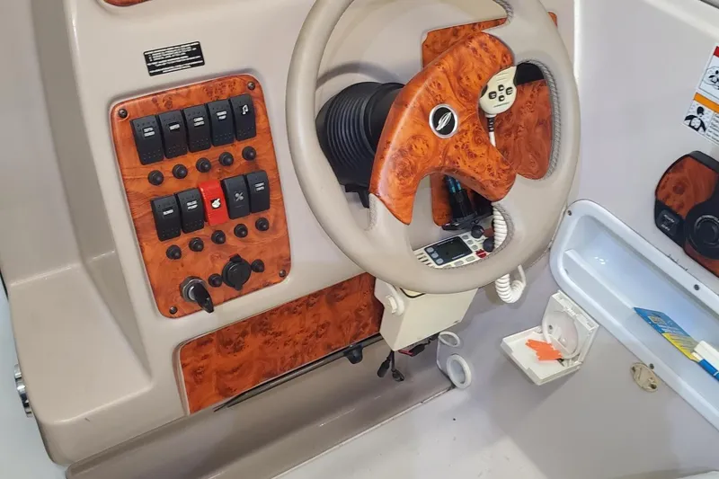 Slide: The Image of 1997 Chaparral Signature 240 dashboard with wood accents and control panel. - 10