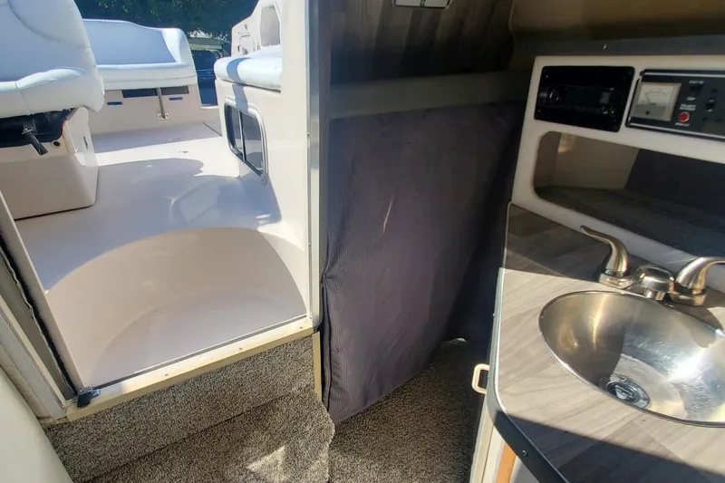 Slide: The Image of 1997 Chaparral Signature 240 interior with seating, sink, and control panel. - 14
