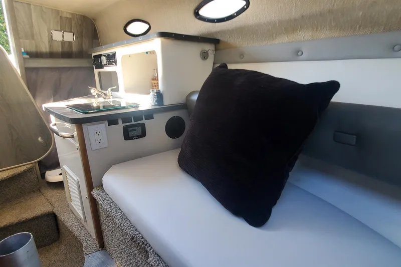 Slide: The Image of Interior of 1997 Chaparral Signature 240 boat with kitchenette and seating area. - 20
