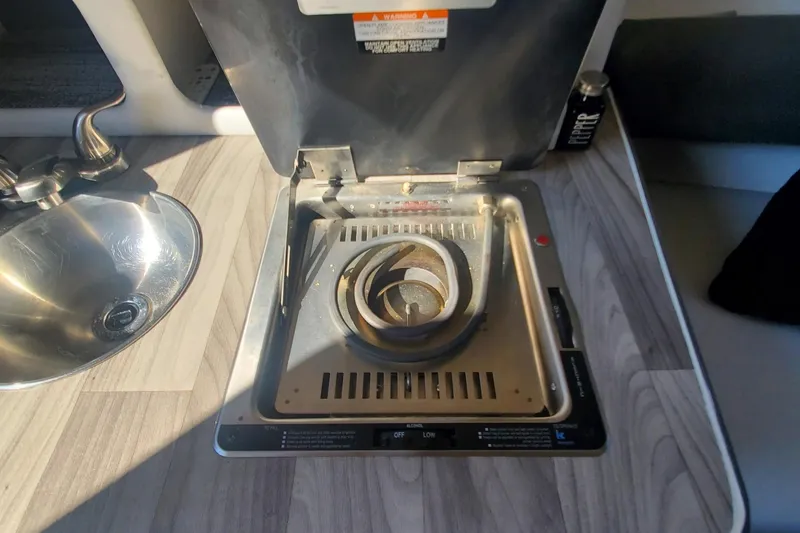 Slide: The Image of 1997 Chaparral Signature 240 boat interior with stove and sink. - 21