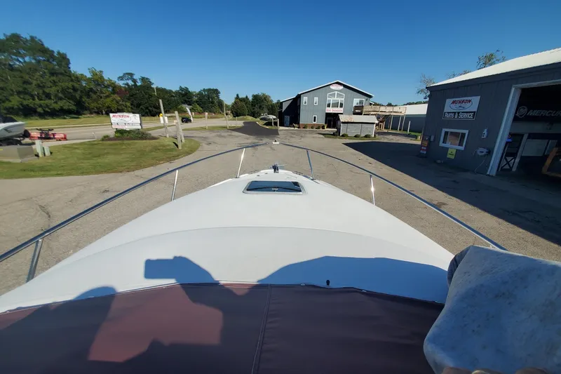 Slide: The Image of 1997 Chaparral Signature 240 boat parked near service center on a sunny day. - 22