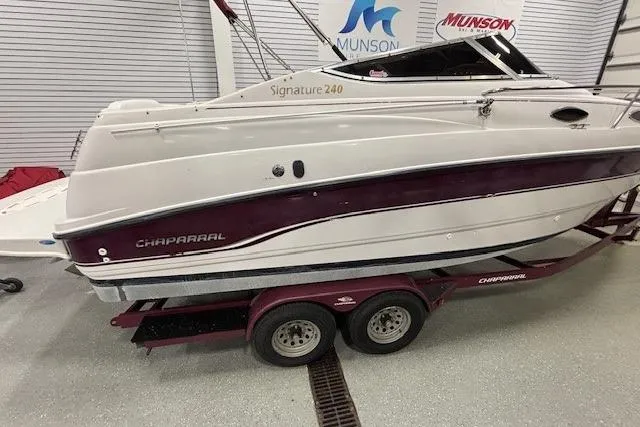 Slide: The Image of 1997 Chaparral Signature 240 boat on trailer in showroom setting. - 30