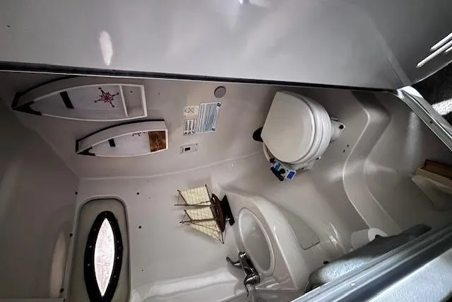 Slide: The Image of Interior of 1997 Chaparral Signature 240 boat bathroom with toilet and sink. - 32