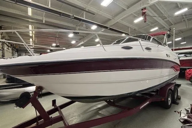 Slide: The Image of 1997 Chaparral Signature 240 boat on trailer in indoor storage facility. - 33