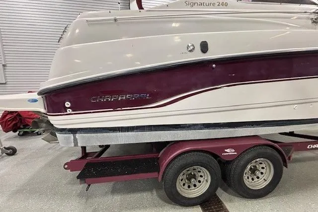 Slide: The Image of 1997 Chaparral Signature 240 boat on a trailer in a garage setting. - 34