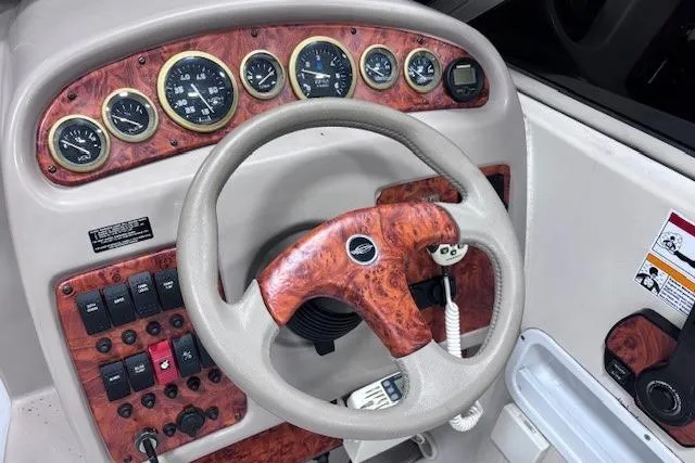 Slide: The Image of 1997 Chaparral Signature 240 dashboard with wood accents and steering wheel. - 39