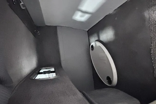 Slide: The Image of Interior cabin of 1997 Chaparral Signature 240 boat, featuring compact design and storage. - 40