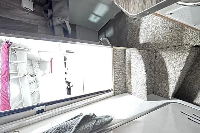 Slide: The Image of Interior view of 1997 Chaparral Signature 240 boat, featuring carpeted stairs and modern design. - 41