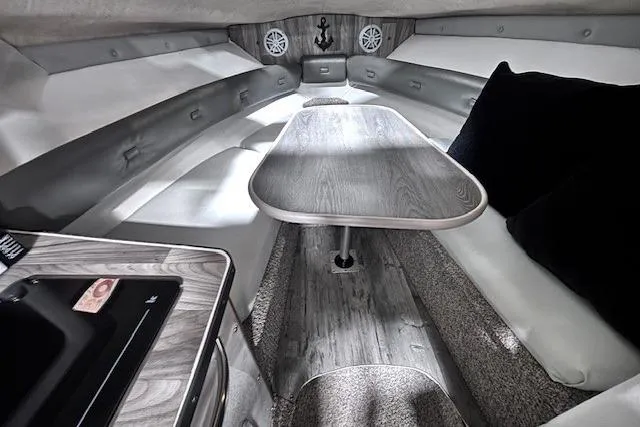 Slide: The Image of 1997 Chaparral Signature 240 cabin interior with seating, table, and modern amenities. - 44