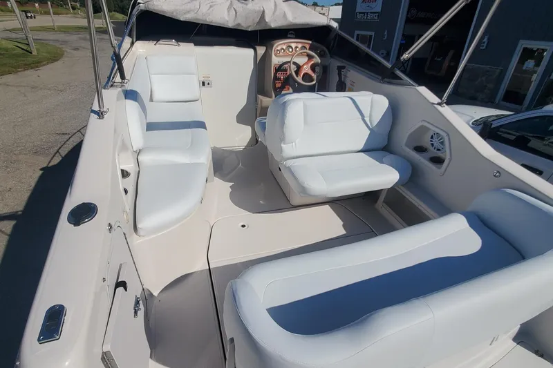Slide: The Image of 1997 Chaparral Signature 240 boat interior with white seating and dashboard. - 5