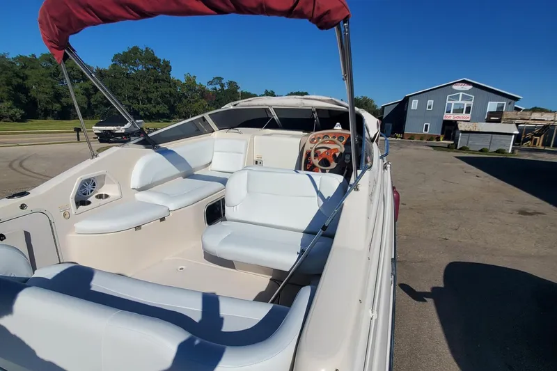 Slide: The Image of 1997 Chaparral Signature 240 boat interior with white seating and red canopy. - 7
