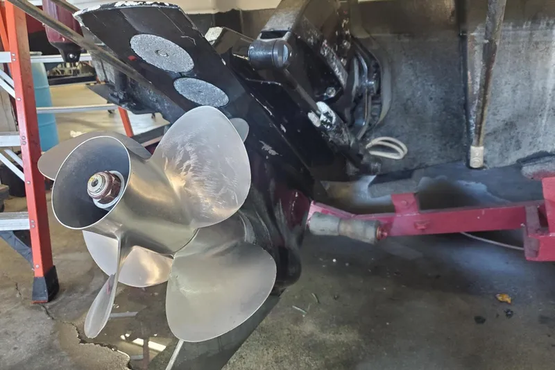 Slide: The Image of 1997 Chaparral Signature 240 boat propeller and drive system in a garage setting. - 9