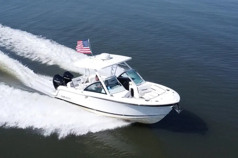 The Image of 2021 Blackfin 252 DC boat cruising on open water with American flag. - 0