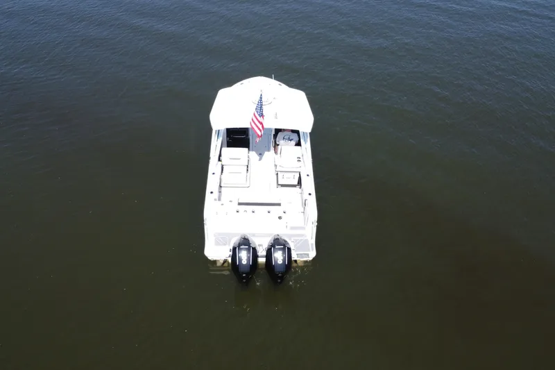 Slide: The Image of Aerial view of 2021 Blackfin 252 DC boat with dual engines on open water. - 18