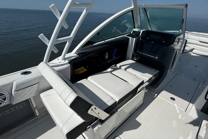 Slide: The Image of 2021 Blackfin 252 DC boat interior with white seating and helm, ocean view. - 28