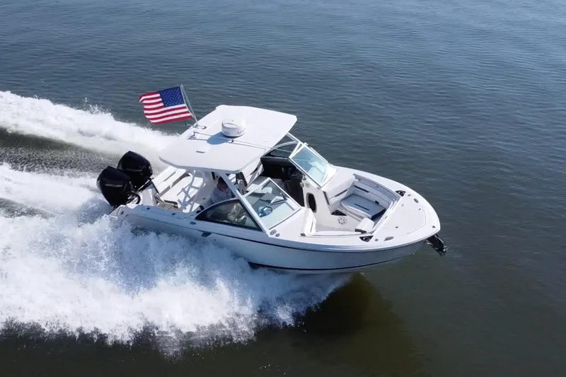 Slide: The Image of 2021 Blackfin 252 DC boat cruising with American flag on open water. - 3