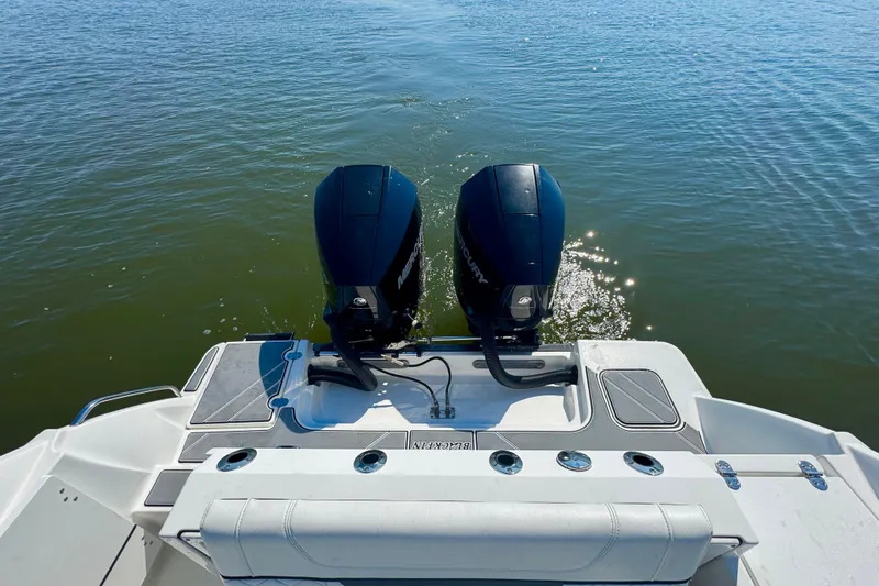 Slide: The Image of 2021 Blackfin 252 DC boat with dual Mercury outboard engines on calm water. - 32