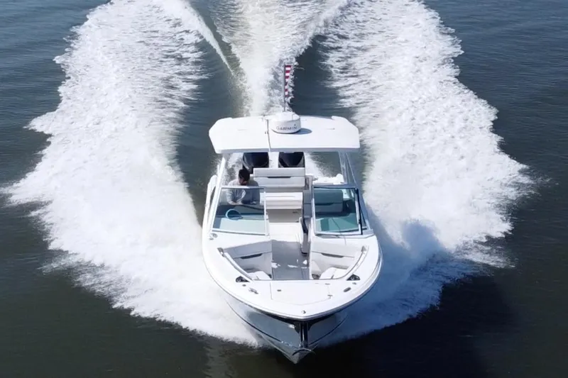 Slide: The Image of 2021 Blackfin 252 DC boat cruising on open water, creating a dynamic wake. - 5