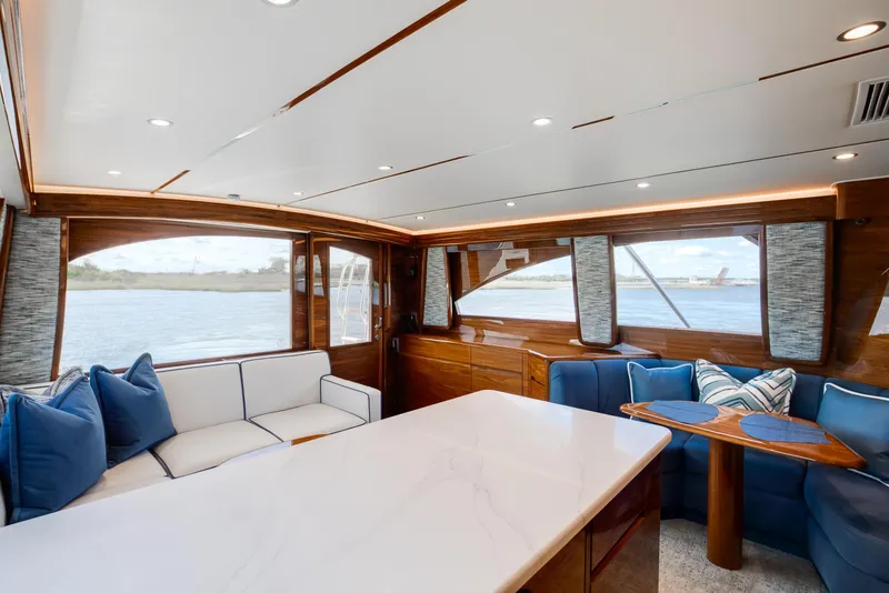 Slide: The Image of Luxurious interior of 2025 Viking 48 Convertible yacht with elegant seating and panoramic windows. - 10