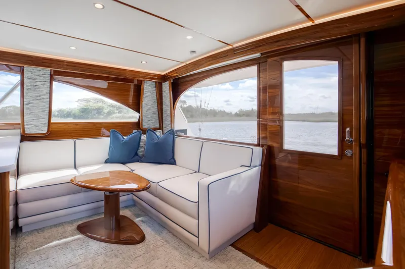Slide: The Image of Luxurious interior of 2025 Viking 48 Convertible yacht with elegant seating and wooden finishes. - 11