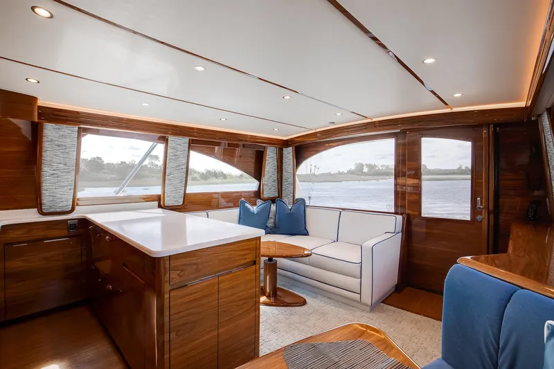 Slide: The Image of Luxurious interior of 2025 Viking 48 Convertible yacht with elegant wood finishes and plush seating. - 13