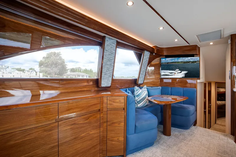 Slide: The Image of Luxurious interior of 2025 Viking 48 Convertible yacht with blue seating and wooden finishes. - 15