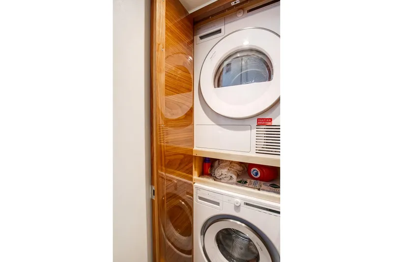 Slide: The Image of Stacked washer and dryer in 2025 Viking 48 Convertible yacht laundry area. - 17