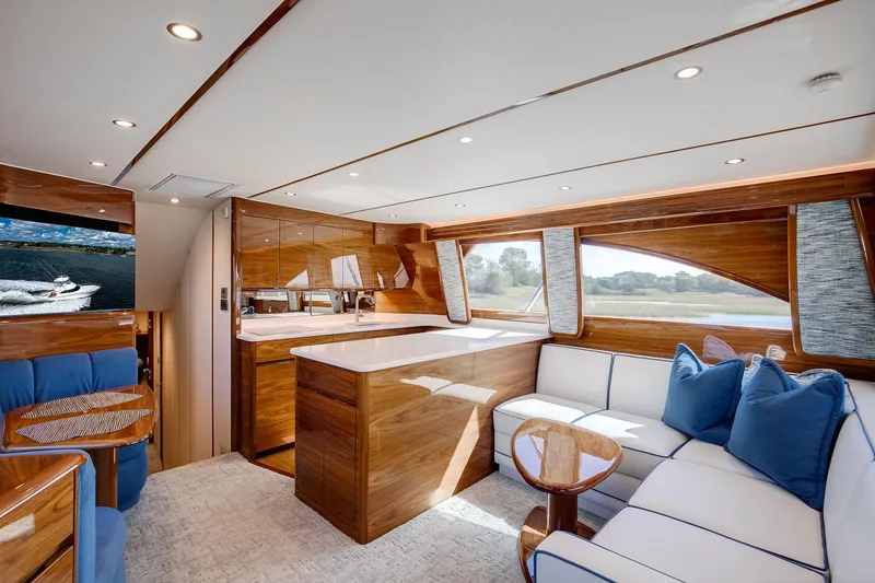 Slide: The Image of Luxurious interior of 2025 Viking 48 Convertible yacht with elegant wood finishes and plush seating. - 18