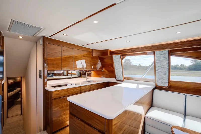 Slide: The Image of Luxurious interior of 2025 Viking 48 Convertible yacht with modern kitchen and seating area. - 19