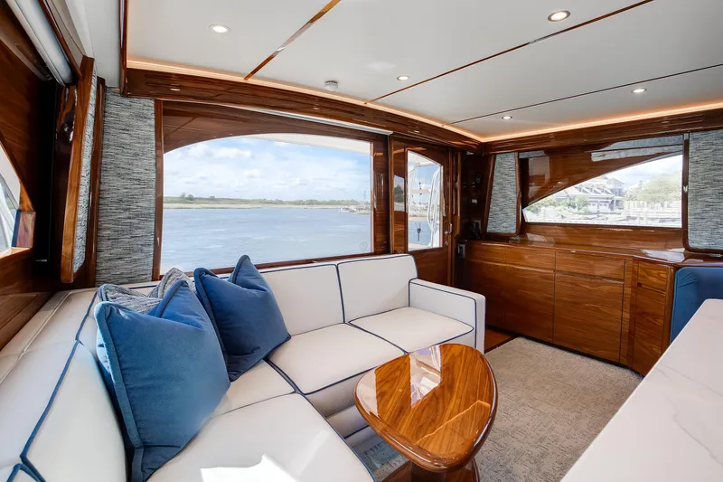 Slide: The Image of Luxurious interior of 2025 Viking 48 Convertible yacht with elegant wood finishes and plush seating. - 22