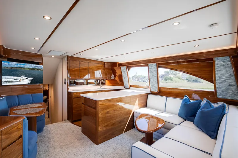 Slide: The Image of Luxurious interior of 2025 Viking 48 Convertible yacht with elegant wood finishes and plush seating. - 23