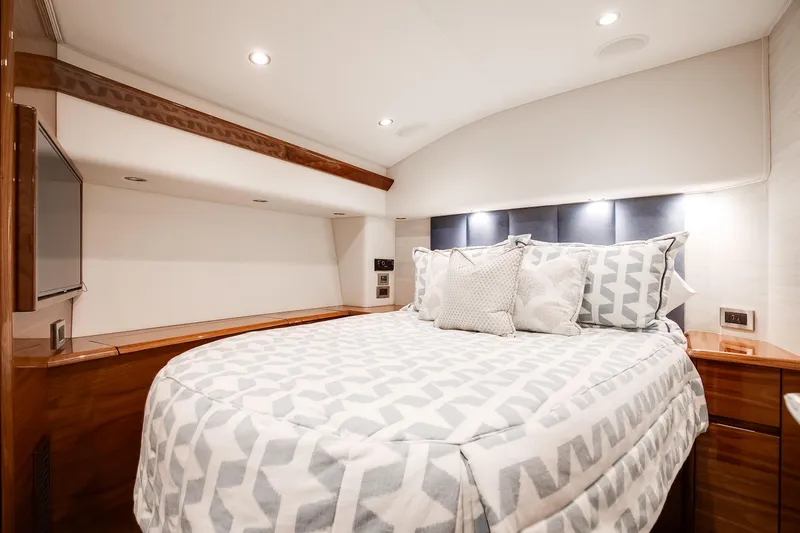Slide: The Image of Luxurious bedroom interior of 2025 Viking 48 Convertible yacht with modern bedding and lighting. - 26