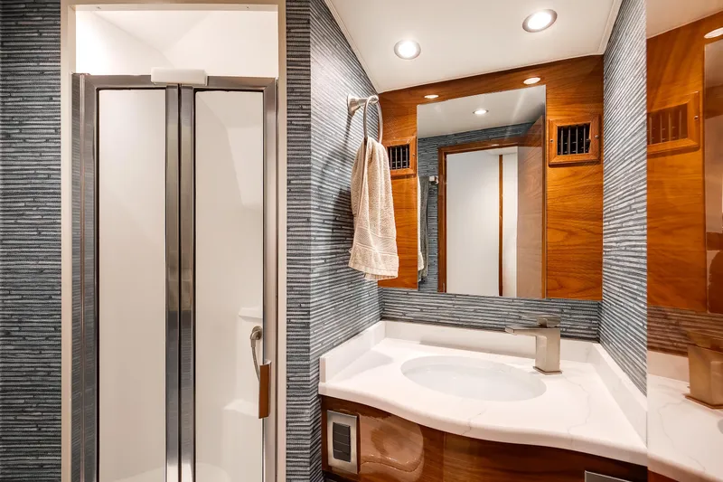 Slide: The Image of Luxurious bathroom in 2025 Viking 48 Convertible yacht with modern fixtures and elegant design. - 28