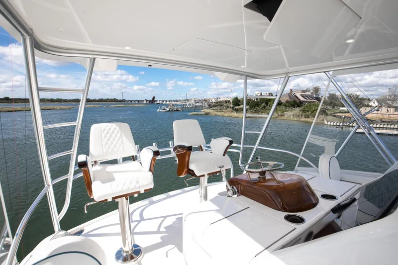 Slide: The Image of Luxurious 2025 Viking 48 Convertible yacht interior with scenic waterfront view. - 29