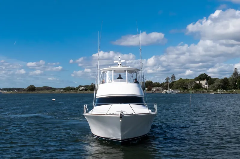 Slide: The Image of 2025 Viking 48 Convertible yacht cruising on a sunny day with blue skies. - 3