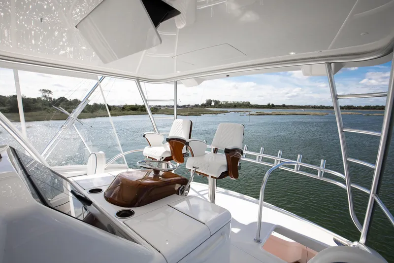 Slide: The Image of Luxurious 2025 Viking 48 Convertible yacht interior with scenic water view. - 30