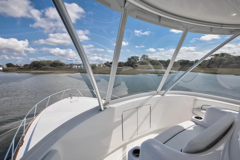 Slide: The Image of 2025 Viking 48 Convertible yacht interior with scenic water view and comfortable seating. - 34