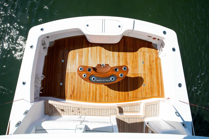 Slide: The Image of 2025 Viking 48 Convertible yacht deck with teak flooring and fishing chair. - 35