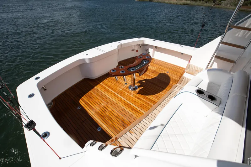 Slide: The Image of 2025 Viking 48 Convertible yacht deck with teak flooring and fishing setup. - 37