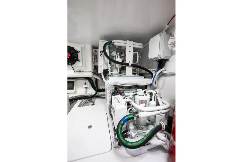 Slide: The Image of Engine room of 2025 Viking 48 Convertible yacht, showcasing complex piping and machinery. - 43